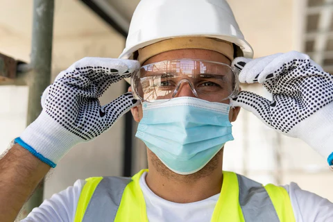 worker wearing safety glasses construction site 480x480
